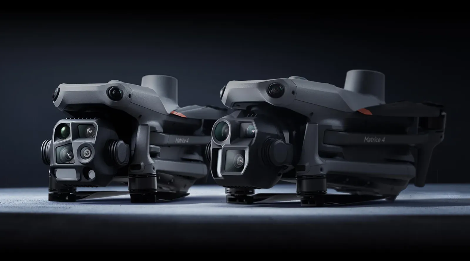 DJI Matrice 4T and Matrice 4E folded side by side, the 4T with its four-lens thermal gimbal at the front