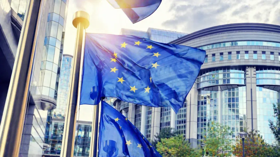 European Commission headquarters in Brussels with EU flags, representing the European Defence Fund announcement