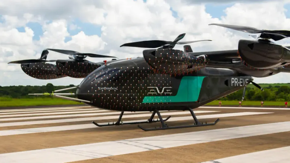 Eve Air Mobility eVTOL aircraft in flight over an urban skyline