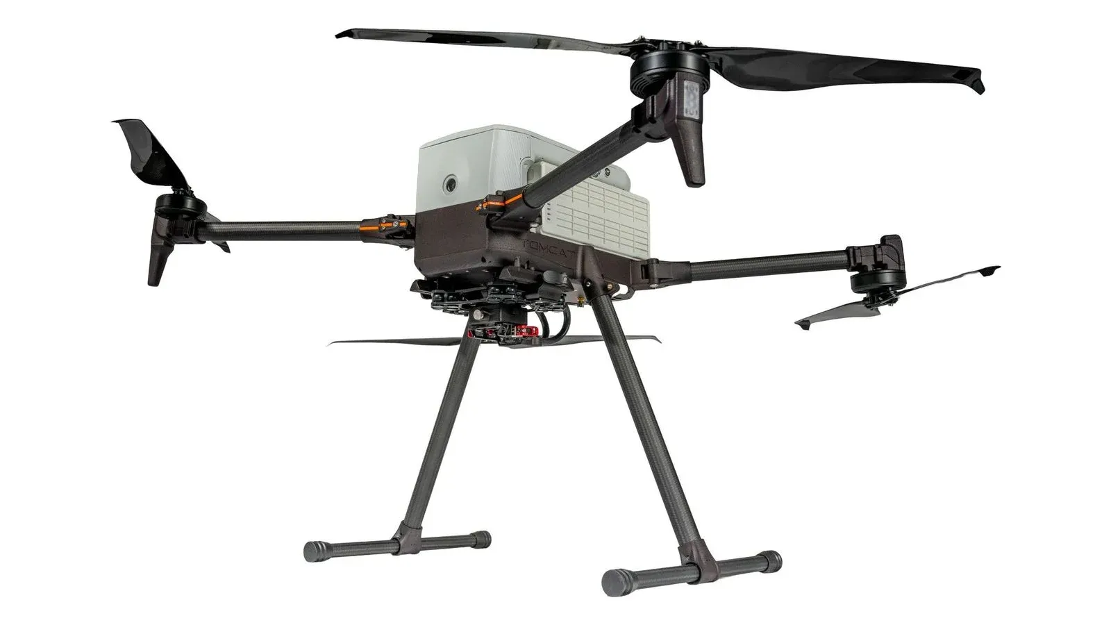 Inspired Flight IF800 Tomcat quadcopter with carbon-fibre arms, folding propellers and tall landing legs, seen from slightly below, on a white background