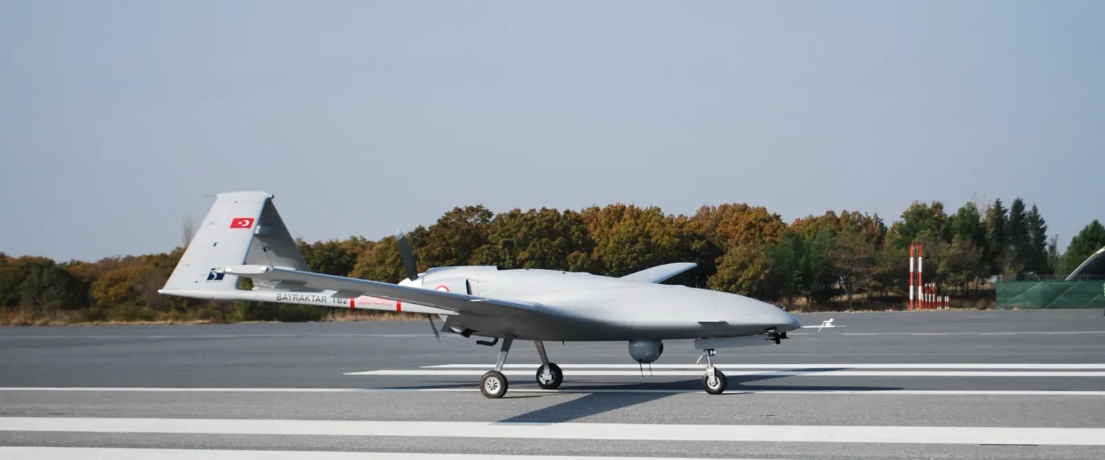 Bayraktar TB2 drone with laser-guided munitions on underwing hardpoints in flight