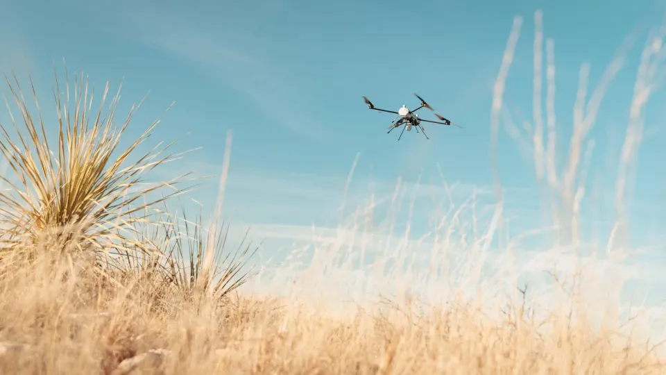 Small military drone in flight during a field test