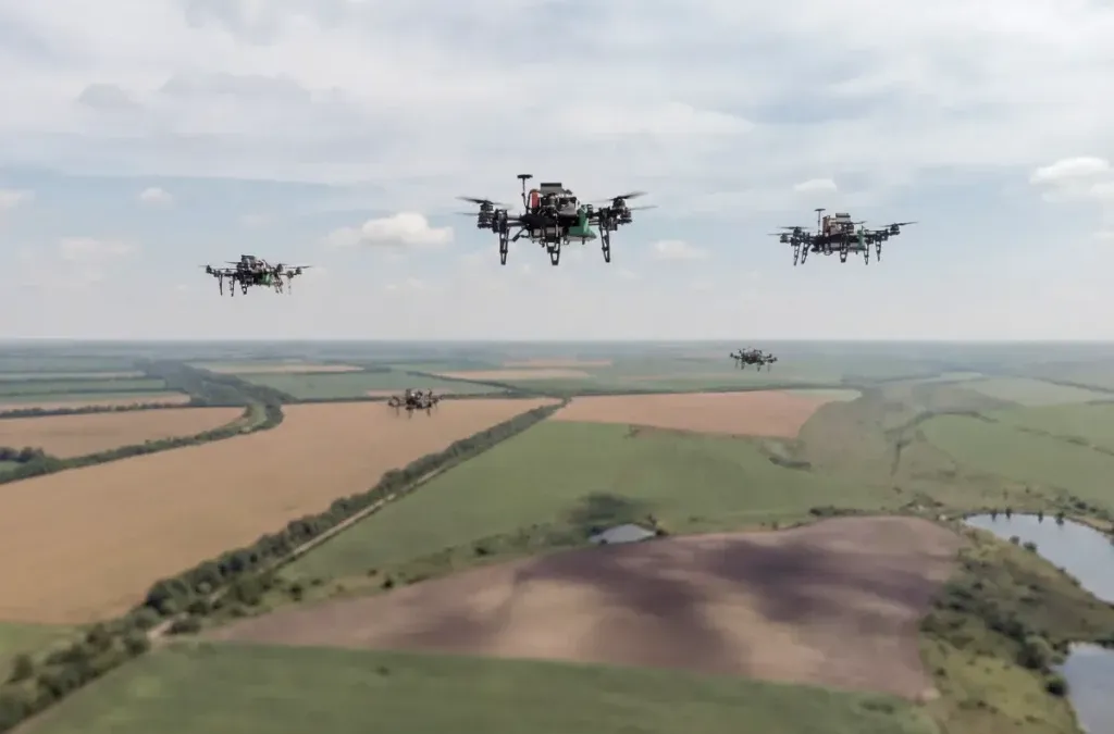 Multiple FPV drones flying in coordinated formation over a Ukrainian battlefield landscape
