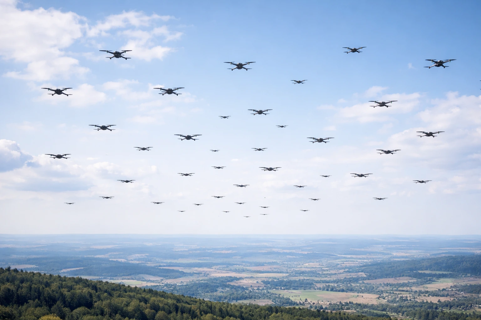 Multiple small drones flying in formation representing the emerging drone swarm threat to military bases