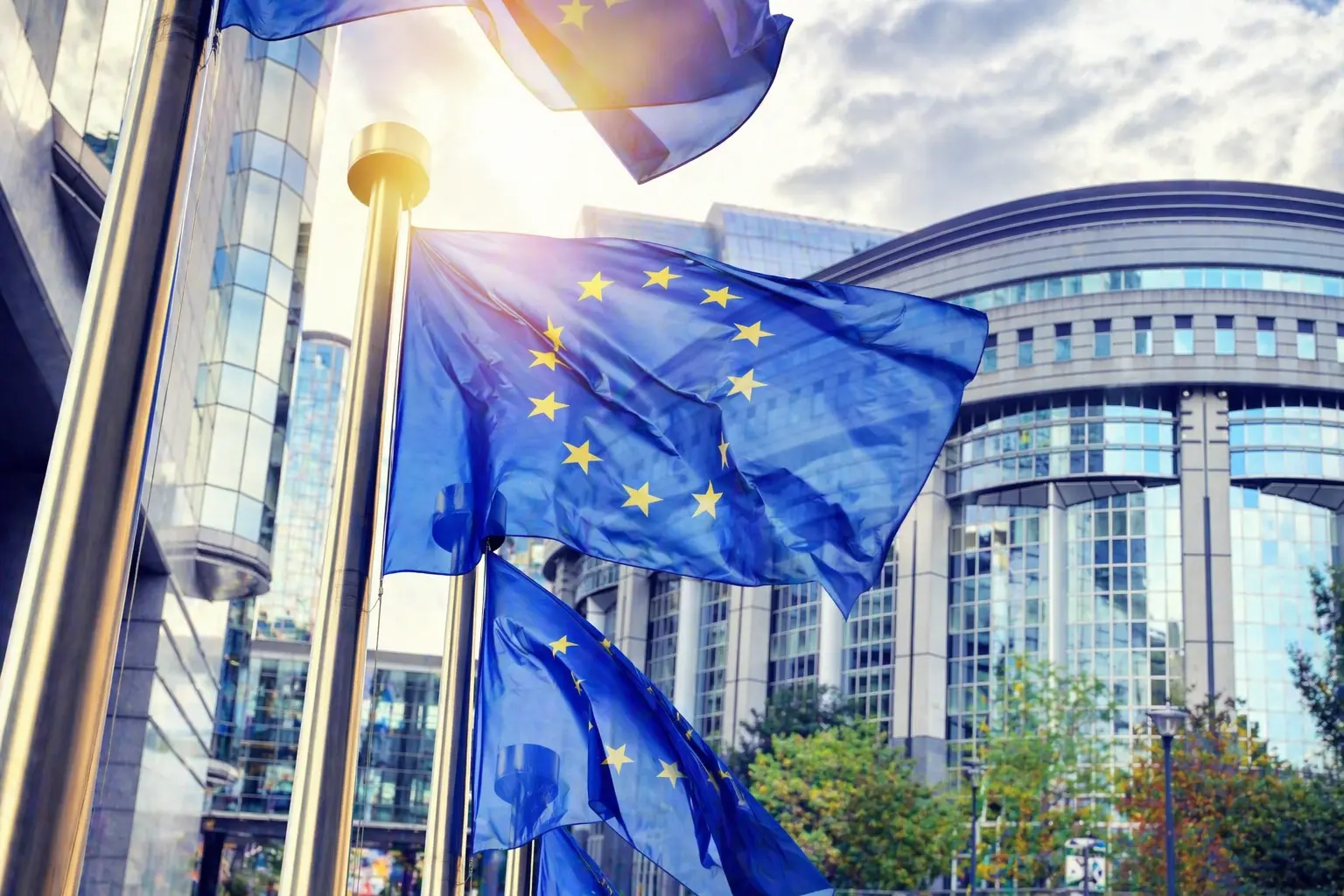 European Commission headquarters in Brussels with EU flags, representing the European Defence Fund announcement
