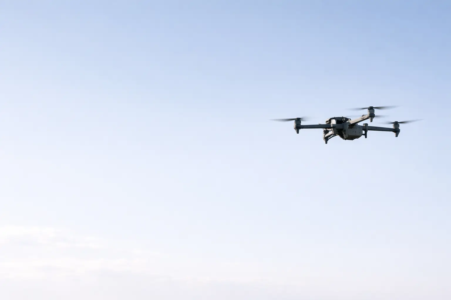 Military drone flying over European countryside during a defense exercise