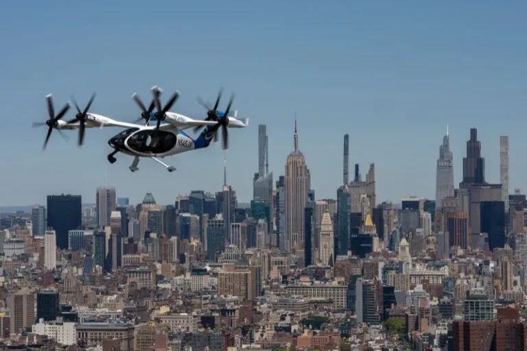 Joby Aviation S4 eVTOL aircraft flying over New York City with Manhattan skyline in background